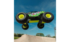 ARRMA Gorgon RC monster truck mid-air above skate ramp, showing neon rims and dynamic body design