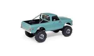 Side view of lifted green SCX30 Chevrolet K10 RC truck with chrome roll bar, 4x4 decals, and rugged tires