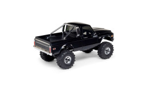 Side profile of black SCX30 Chevrolet K10 RC truck with V8 and SCX10 decals, chrome wheels, and roll bar