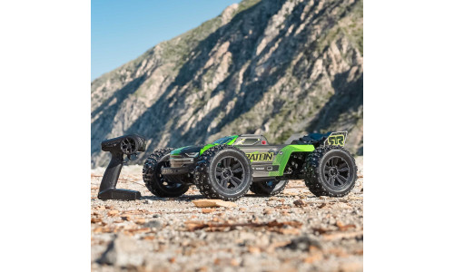 Arrma 1/8 scale RC truck racing across rough terrain with clipless body secured