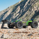 Arrma 1/8 scale RC truck racing across rough terrain with clipless body secured