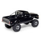 Side profile of black SCX30 Chevrolet K10 RC truck with V8 and SCX10 decals, chrome wheels, and roll bar